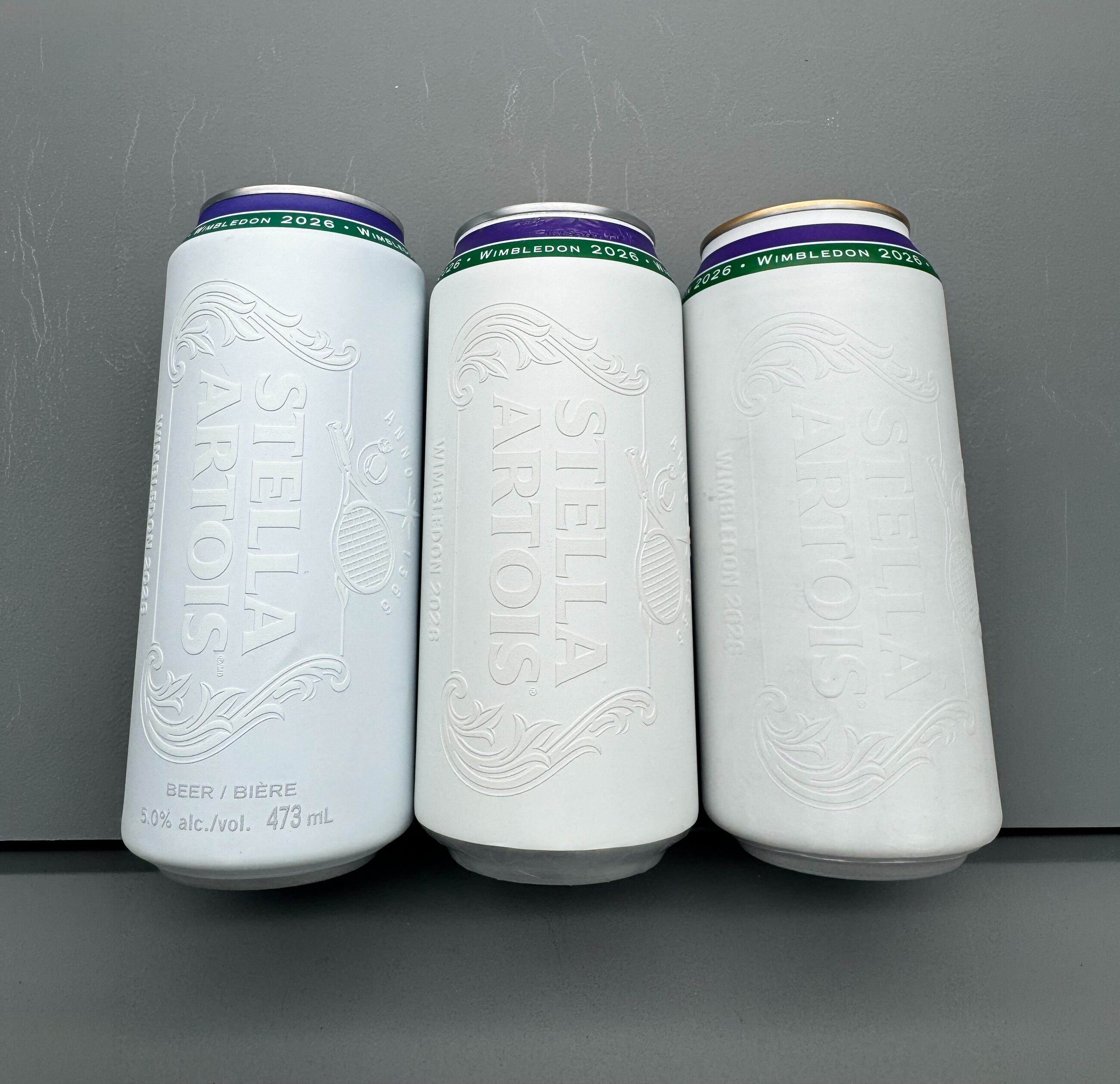 Three finished cans showing the completed design