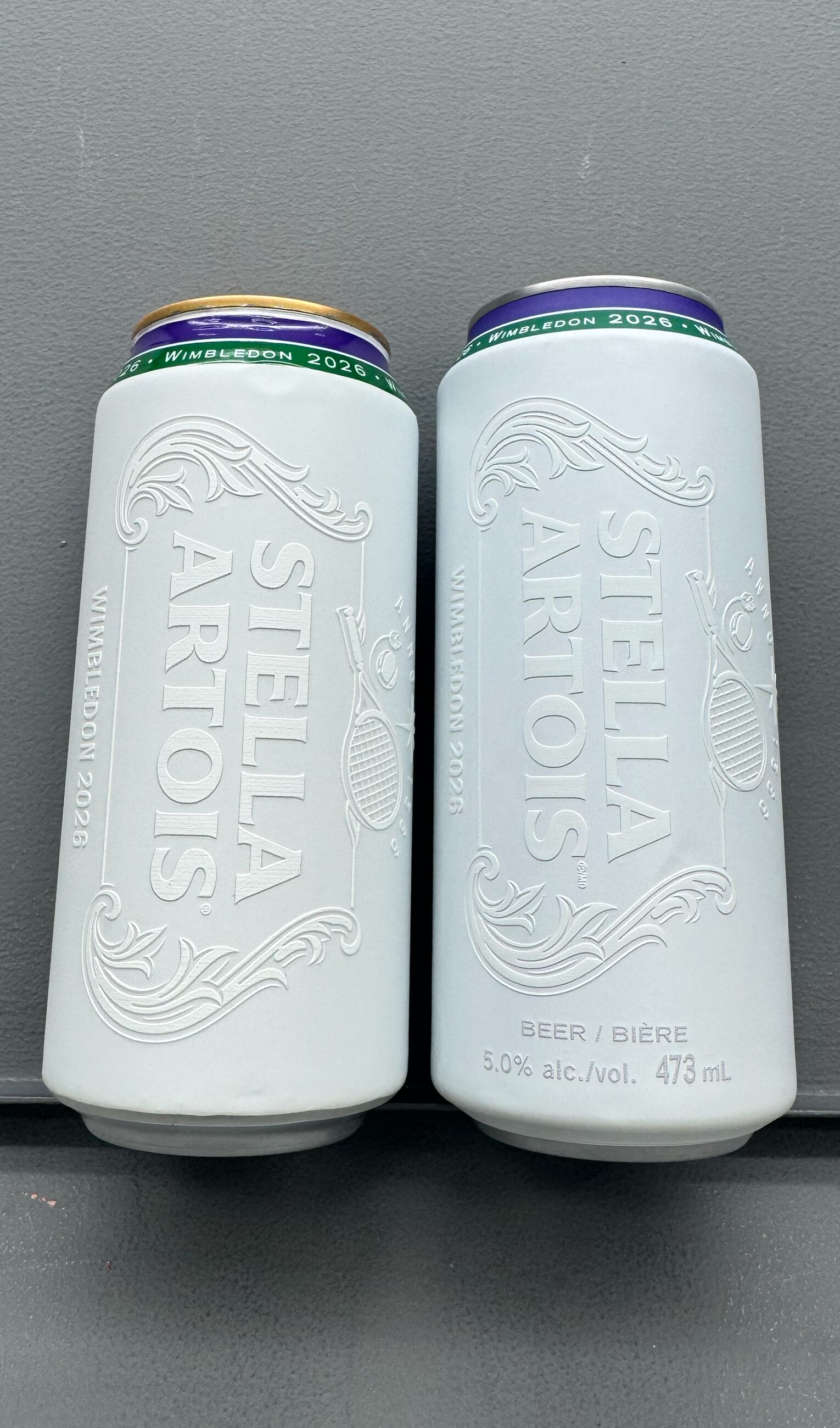 Two finished cans showing the embossed high-build varnish