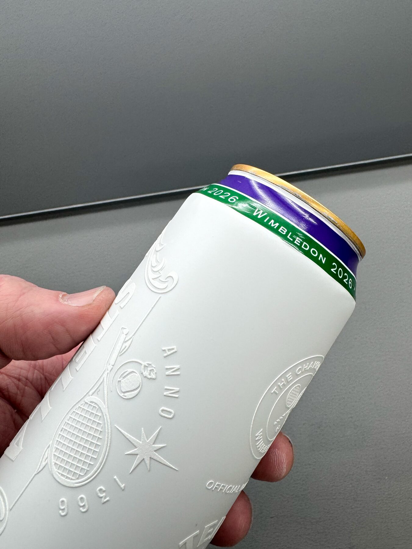Crest detail on a finished can, held in the hand