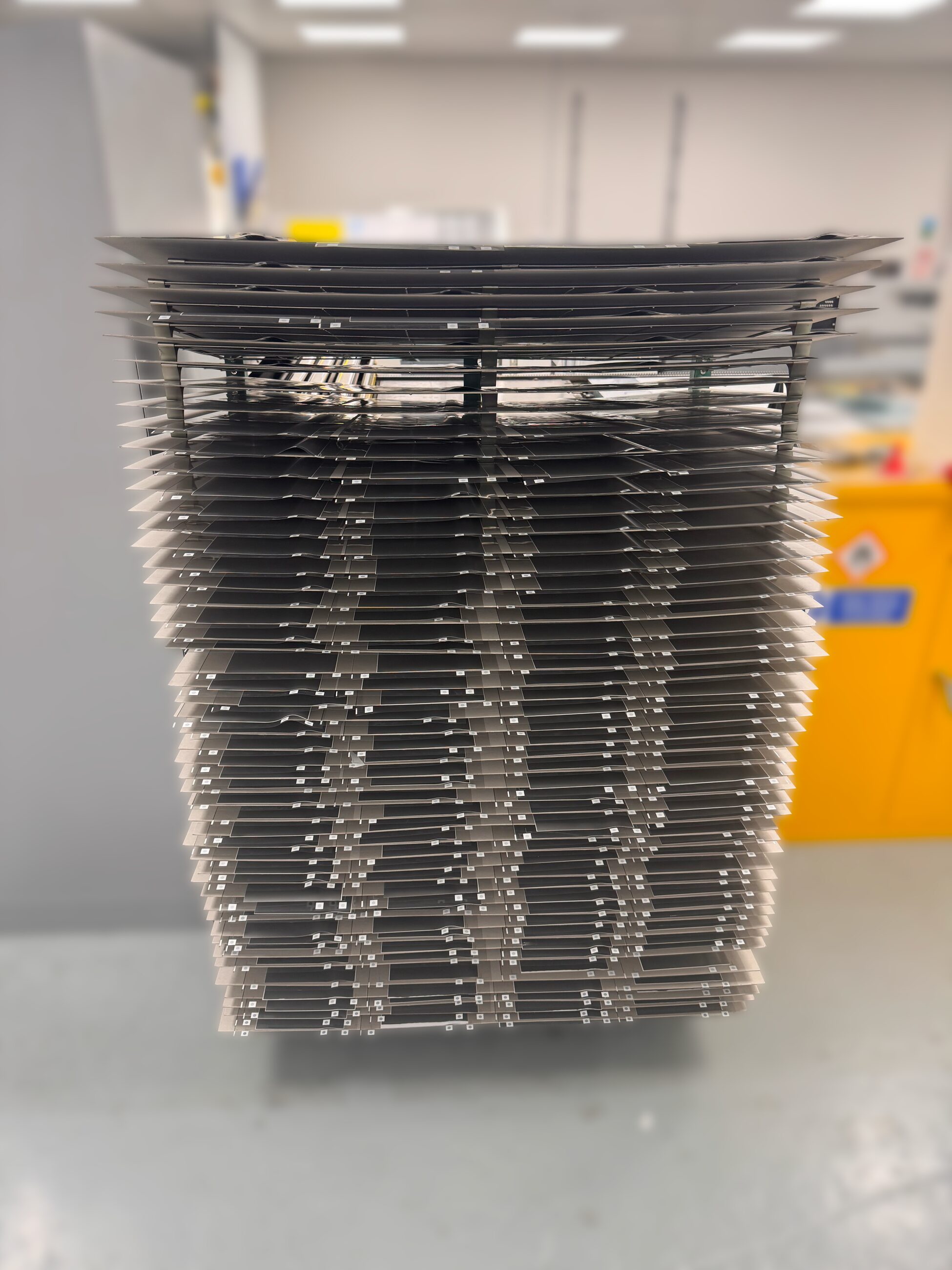 Silk screen frames racked between production stages